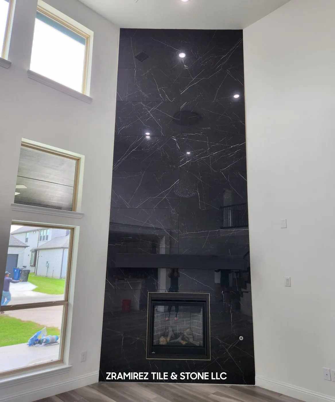 After: Two-story fireplace wall, from framing to black marble-look large-format porcelain