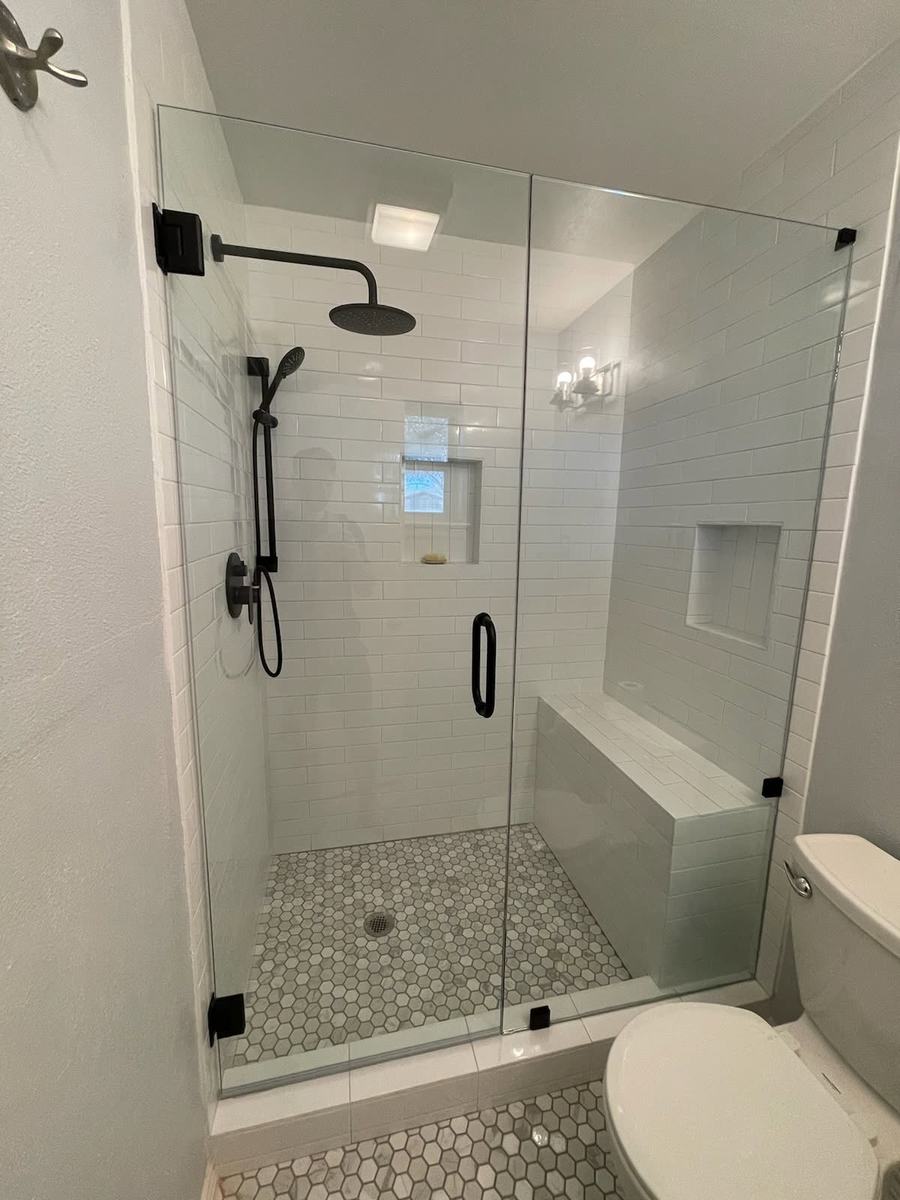 Walk-in shower with bench and frameless glass