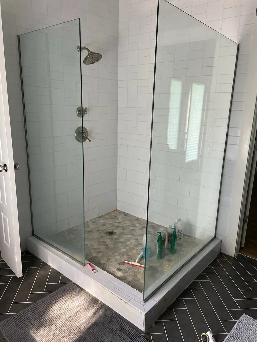 Subway tile shower with hex floor and glass door