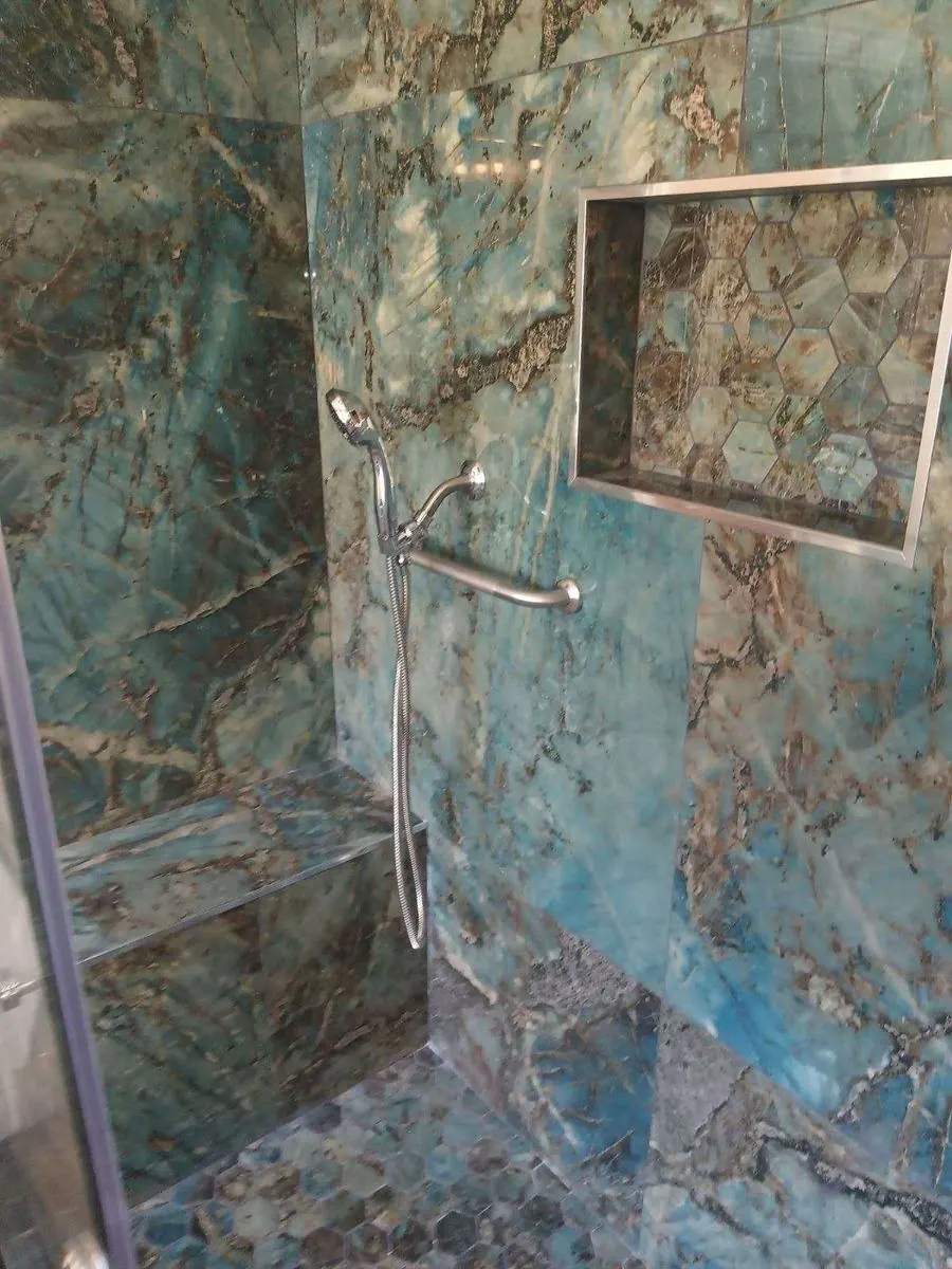 Green marble-look slab shower with niche