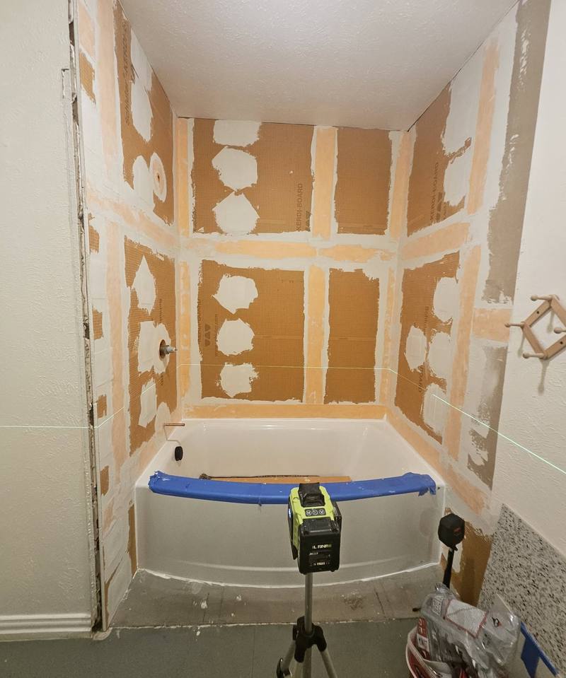 Laser level set up for tile layout on a prepared tub surround