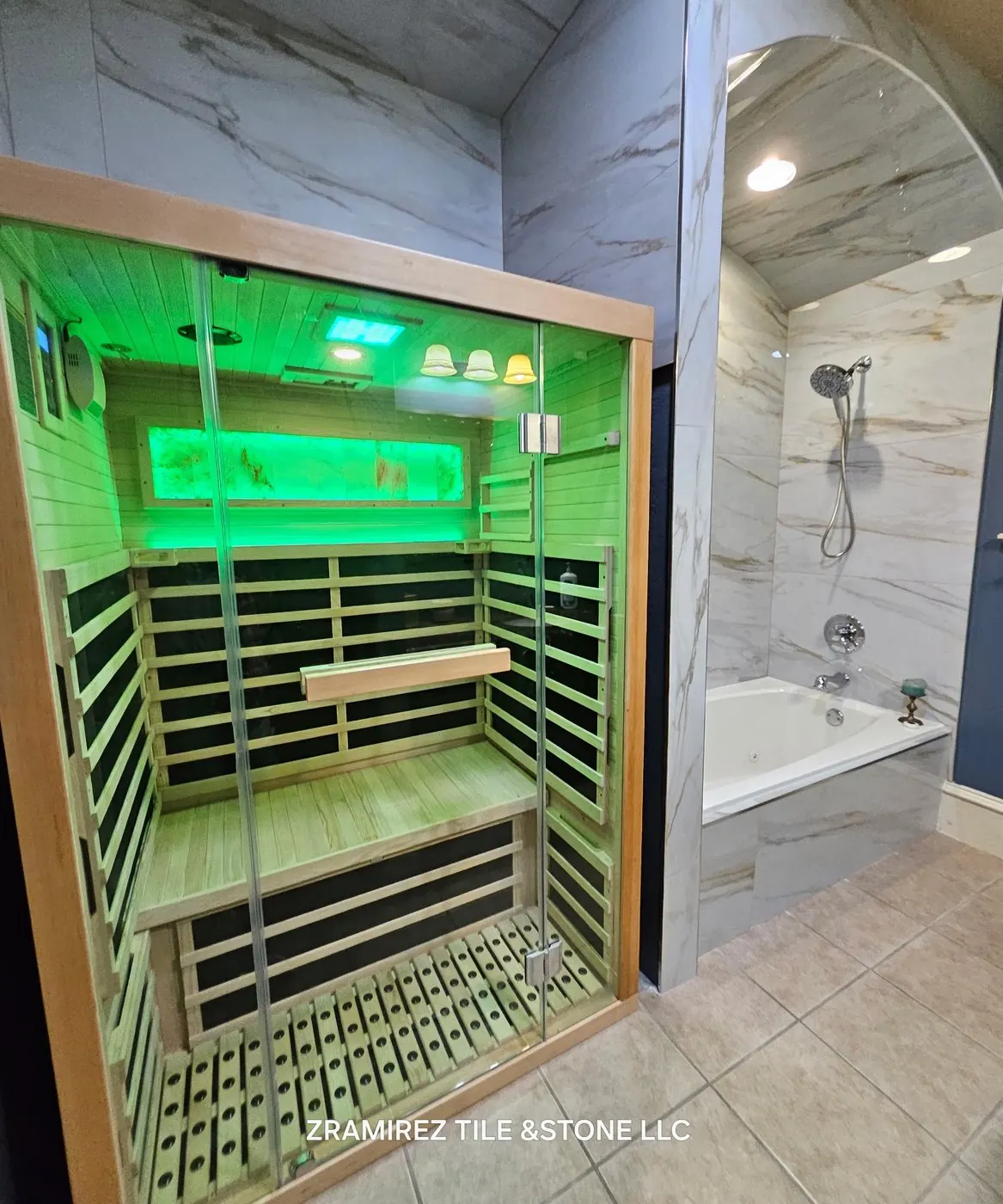 Infrared sauna installed beside a marble-look tub surround
