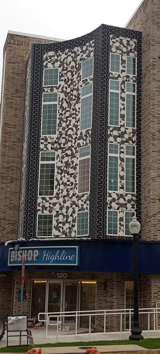 Black-and-white mosaic tile tower on a building exterior