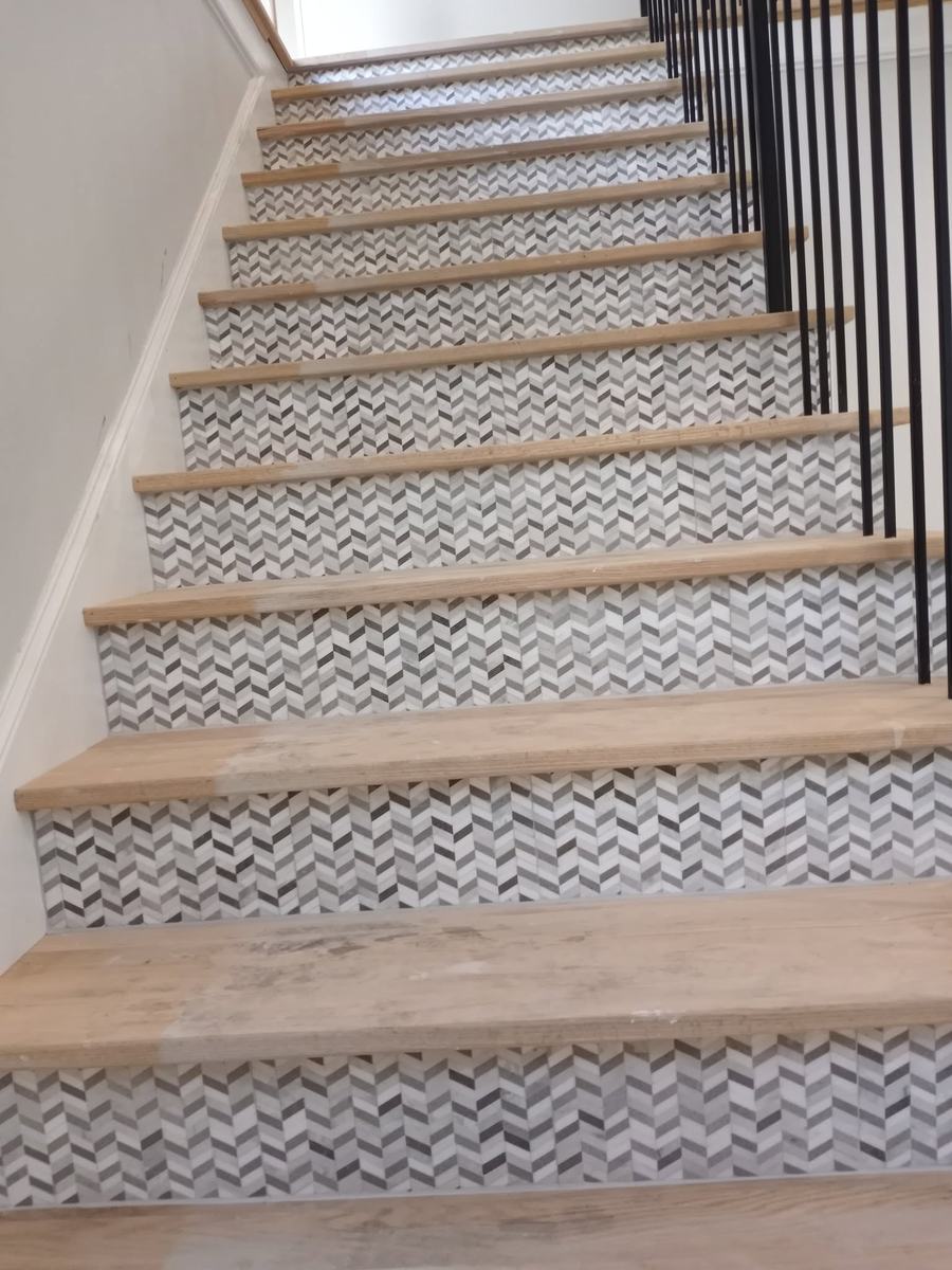 Staircase with patterned tile risers and wood treads