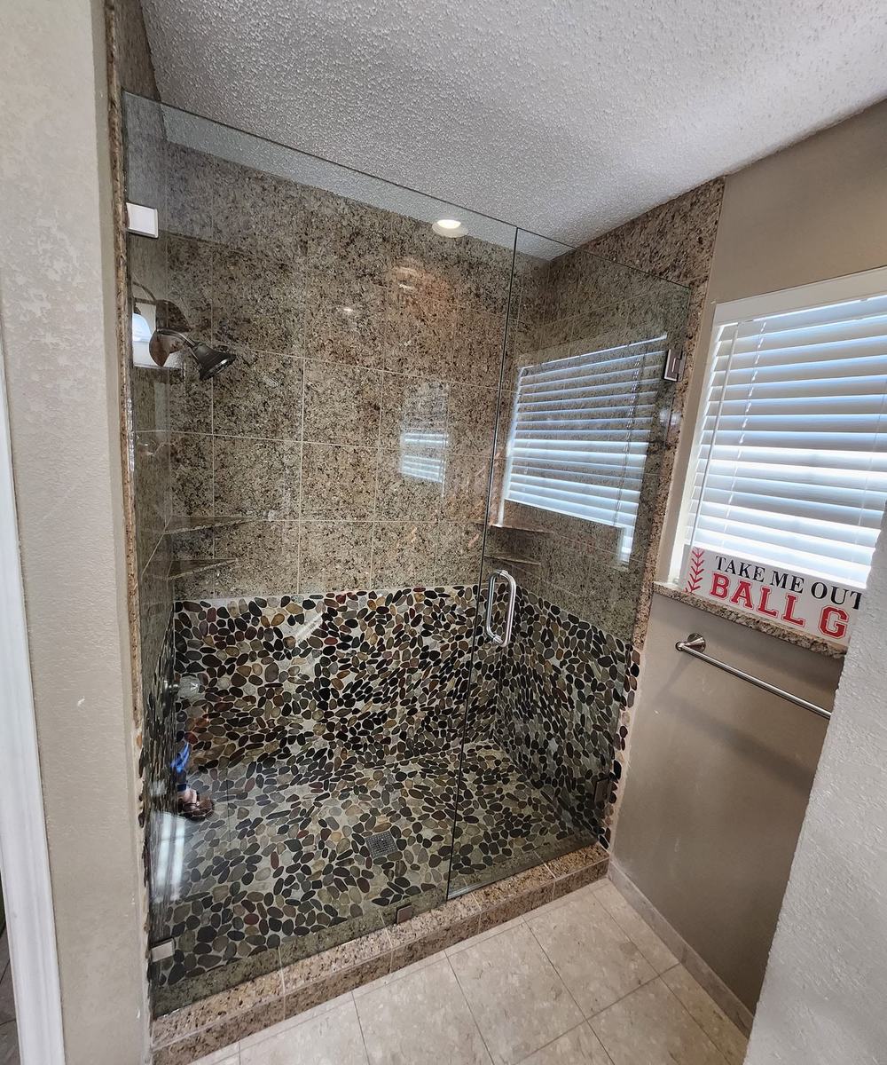 Shower with pebble floor and mosaic walls