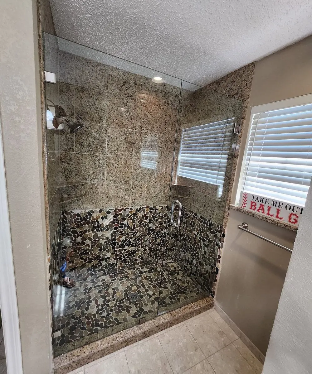 Shower with pebble floor and mosaic walls
