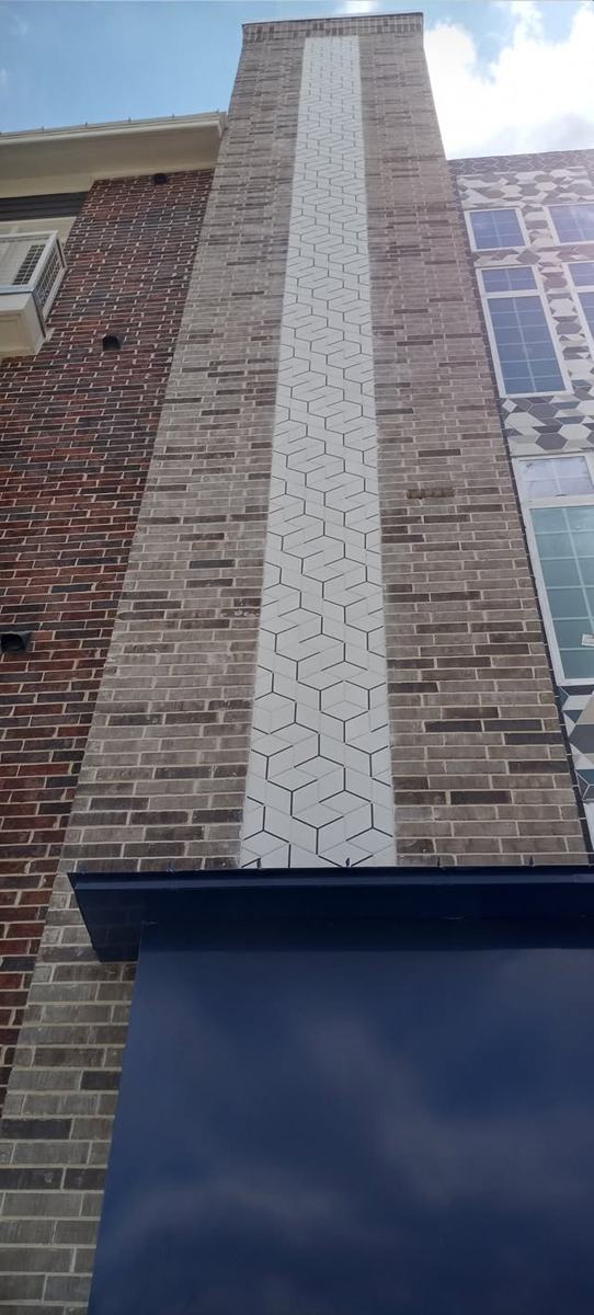 Exterior column with a white geometric tile inlay