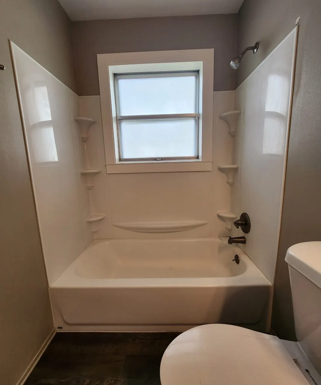 Before: Acrylic tub surround replaced with a marble-look walk-in shower and hex mosaic floor